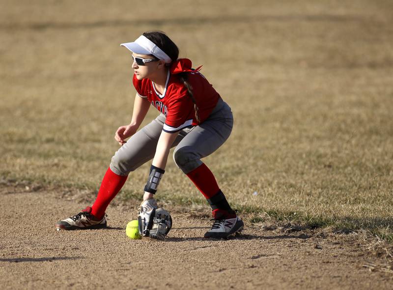 West Aurora’s Katelyn Serafin picks up a ground ball during a game against Geneva during a home game on Wednesday, March 16, 2022.