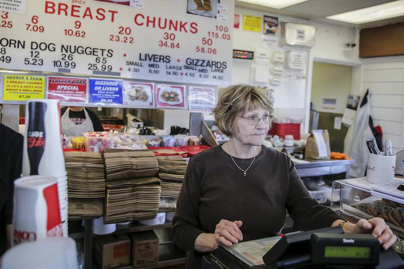 Pat Reimer takes an order during the Monday lunch rush at Chicken-n-Spice in Joliet.