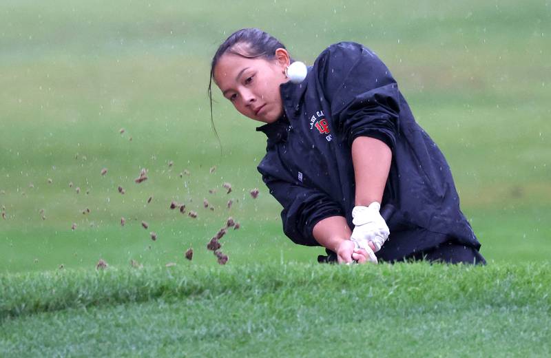 LaSalle-Peru’s Sophia Chiu blasts her ball out of the sand trap on the second hole Tuesday, Sept. 24, 2024, during the Interstate 8 girls golf tournament at the Sycamore Golf Club.