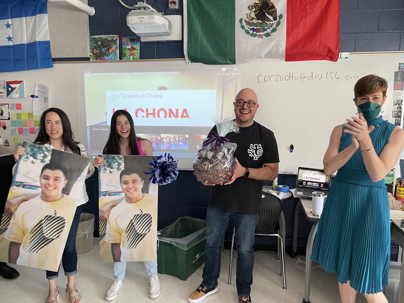 McHenry High Spanish teacher Otto Corzo receives the Golden Apple Award for Excellence in Teaching, Friday, May 13, 2022. Corzo is pictured, from left to right, with his wife Irene, his daughter Laila and Pam Witmer, chief of staff at the Golden Apple Foundation.