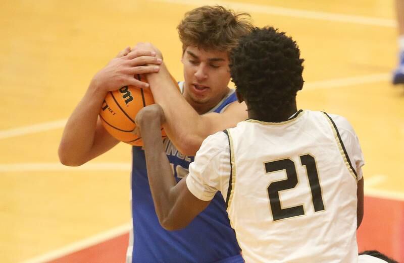 Princeton's Asa Gartin takes the ball away from Oak Forest's Enoch Olukolade during the Dean Riley Shootin' The Rock Thanksgiving Tournament on Tuesday, Nov. 26, 2024 in Kingman Gym at Ottawa High School.