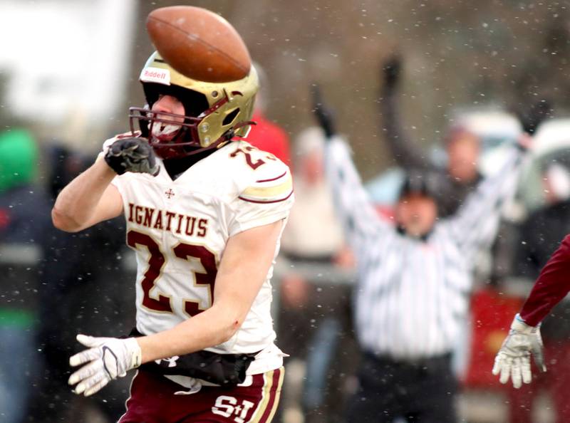 St. Ignatius’ Vinny Rugai tosses the ball in celebration as he scores a touchdown against Prairie Ridge in Class 6A football playoff semifinal action at Crystal Lake on Saturday.