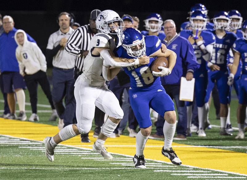 Newman’s Matthew Blackert is hauled down by Monmouth-Roseville’s Andy Myers after an interception Friday, Oct. 25, 2024, at Roscoe Eades Stadium in Sterling.