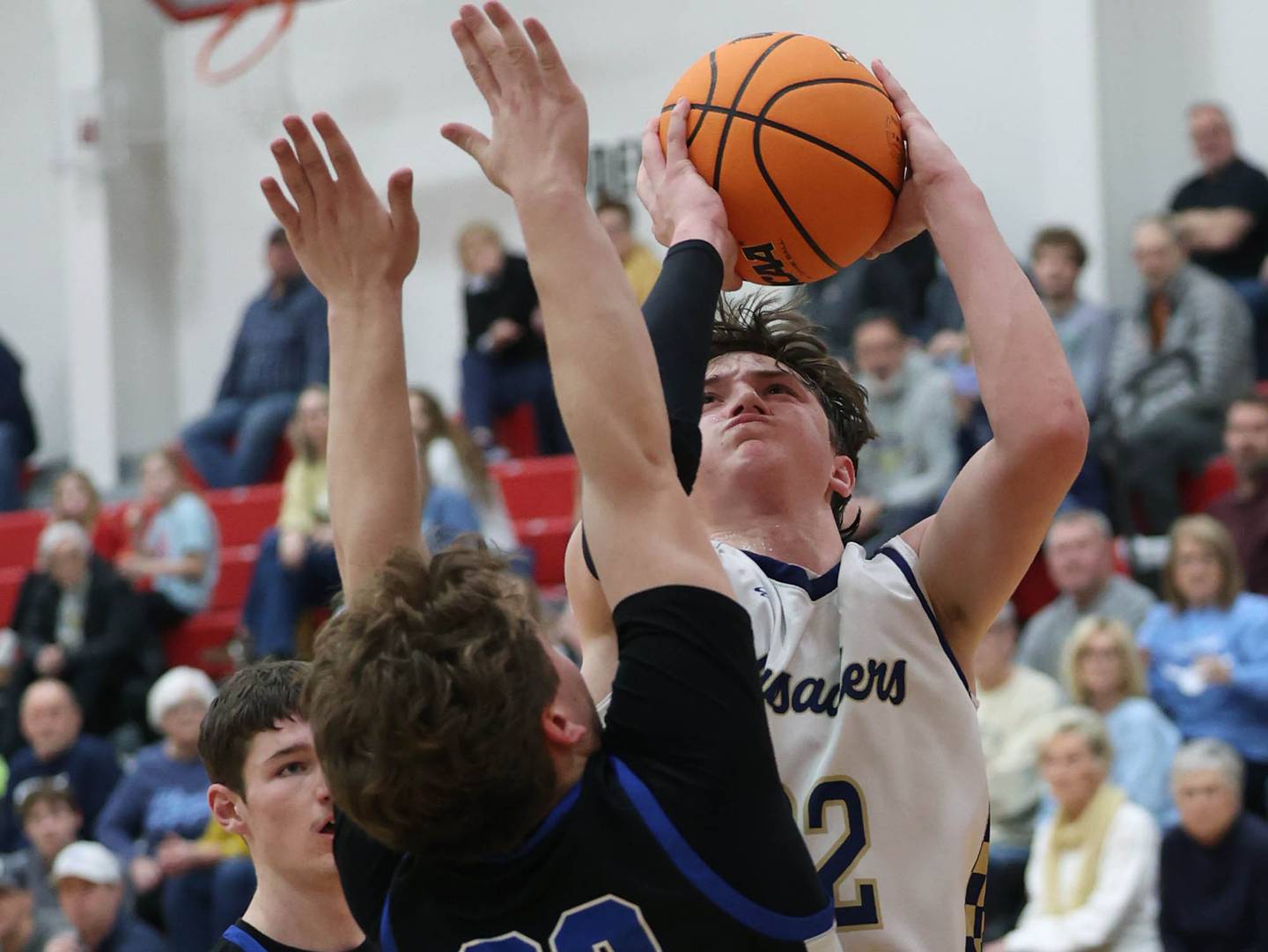 Marquette's Griffin Dobberstein shoots over Hinckley-Big Rock's Luke Badal Tuesday, March 3, 2026, during their sectional semifinal matchup at Amboy High School.
