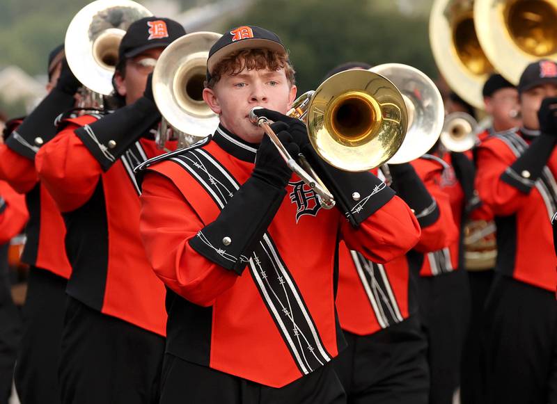 Members of the DeKalb High School marching band head down Dresser Road Wednesday, Sept. 27, 2023, during the homecoming parade.