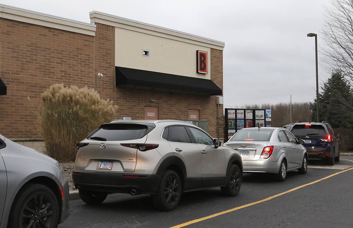 People wait in the drive through line to buy coffee on Tuesday, Dec. 10, 2024, at Biggby Coffee on their first day of business in McHenry.