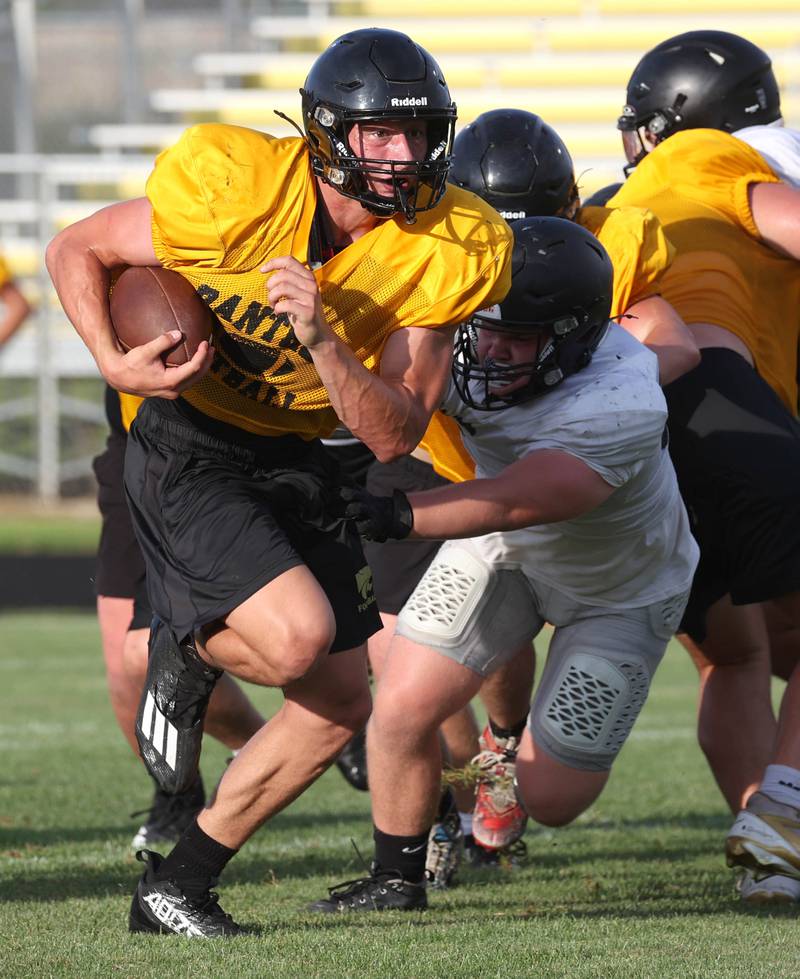 Lena-Winslow’s Aiden Wild carries the ball as they scrimmage Sycamore Thursday, July 24, 2025, during a joint practice with Byron, Lena-Winslow and Sycamore at Sycamore High School.