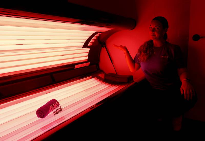 Stephanie Szablewsk, the owner of Tropic Tan Company in Crystal Lake, inside her tanning salon on Friday, Feb. 25, 2022. She plans to open the tanning salon 24 hours a day starting in early March.