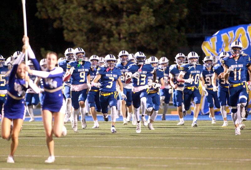 Wheaton North players take the field before their home game on Friday, Sept. 27, 2024 against Batavia.