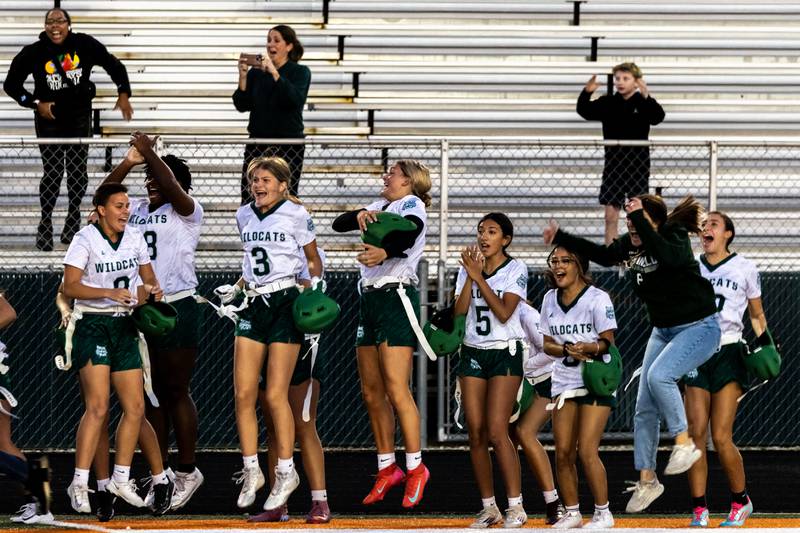 Plainfield Central players celebrate on the sidelines after scoring the game-winning touchdown during a varsity flag football Romeoville Regional semifinal game against Bradley-Bourbonnais at Romeoville on Oct. 7, 2025.