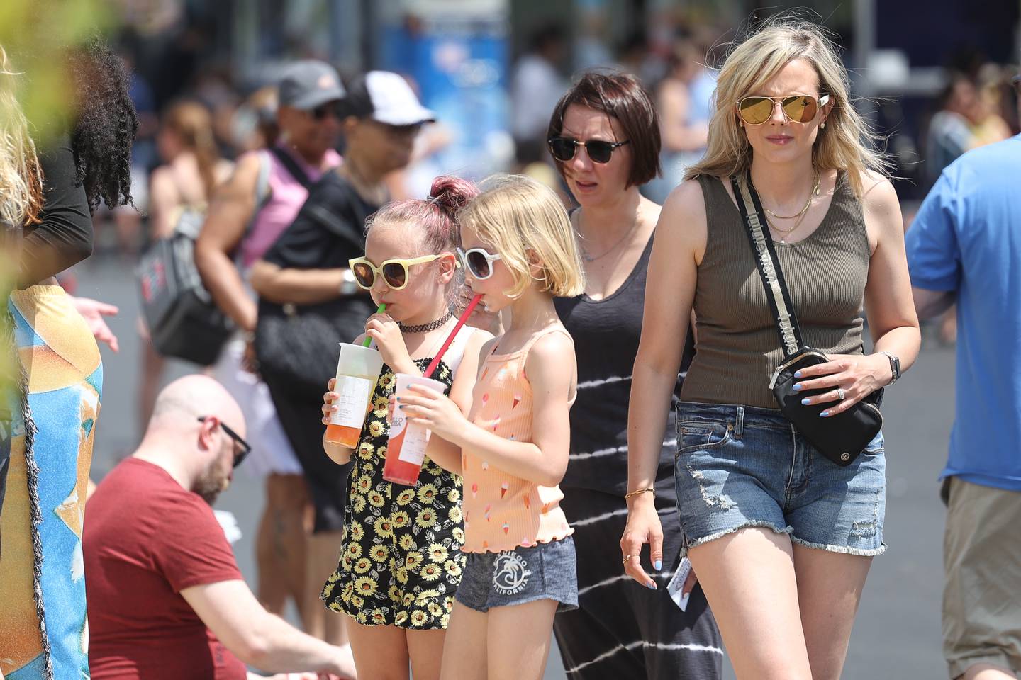 Grace Sula, left to right, and her friend Brooklyn Winder enjoy lemonade while spending time with their mothers Megan Sula and Michelle Winder at the World of Food Trucks on Saturday, May 18, 2024 at Renwick Community Park in Plainfield