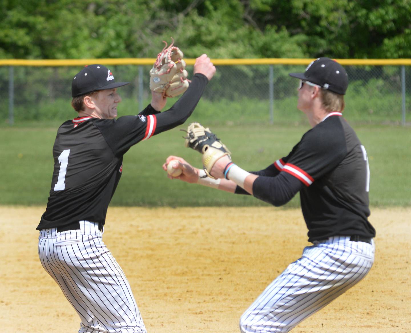 Fulton first baseman  Jacob Huisenga and relief pitcher Braedon Meyer celebrate after the final out sealing a 7-4 win over Forreston at the 1A Amboy Regional on Saturday, May 24, 2025.