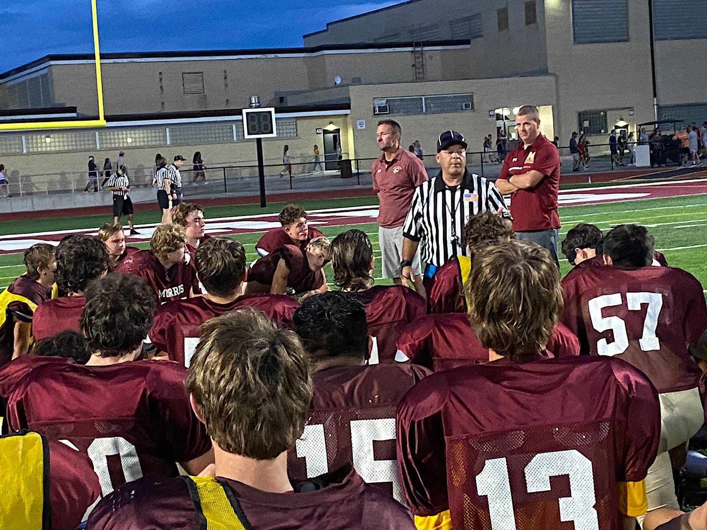 IHSA official Tom Hug talks to the Morris football team Friday night after the Maroon & White scrimmage.
