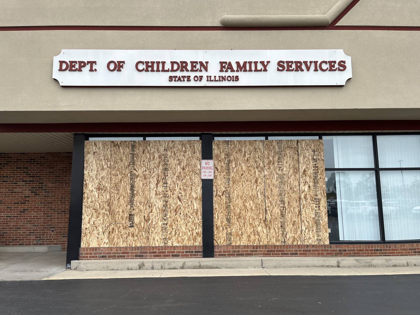 Boarded-up windows at the Joliet office for the Illinois Department of Human Services, 1619 W. Jefferson St., seen on Tuesday, May 24, 2022. A shooting reported on Saturday, May 21, 2022, caused damage to the windows to the building.