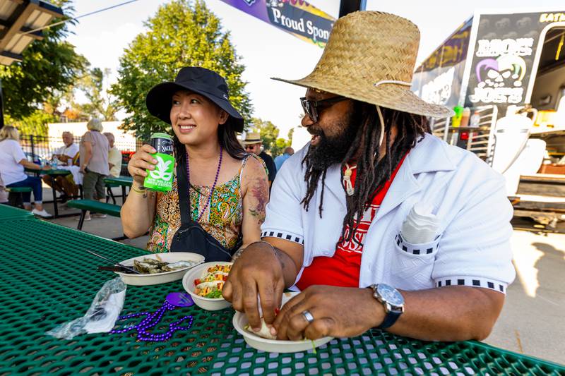Joliet residents Sabay and Bre Hill enjoy authentic Cajun food from Moe Joes during New Orleans North Festival held at the Joliet Slammers Stadium on Aug. 16, 2024.