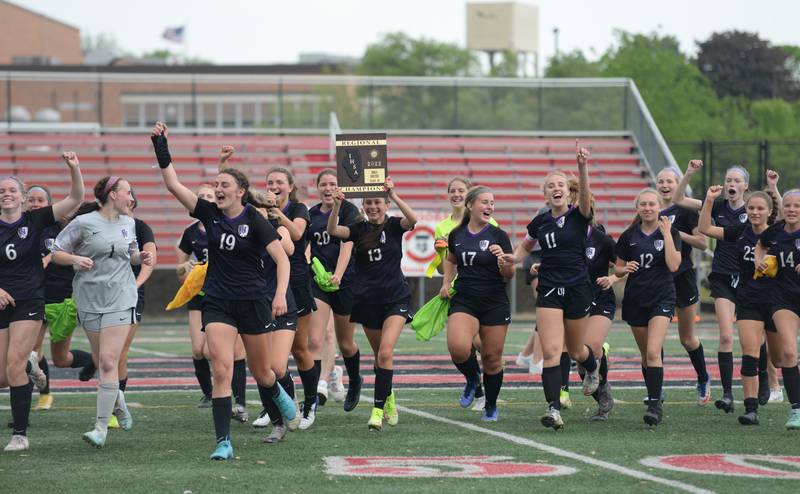 Downers Grove North runs towards their fans with the winning trophy during the regional final game against Glenbard East Friday May 20, 2022.