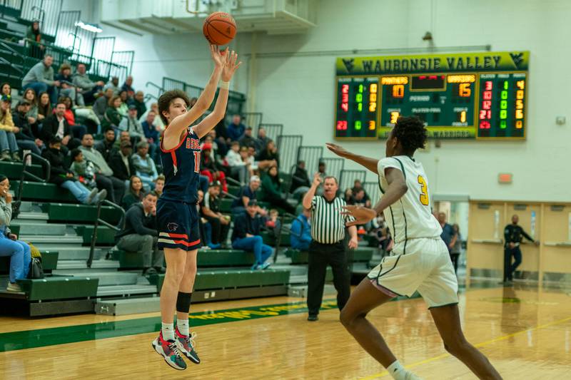 Oswego’s Josh Nelson (10) shoots a three-pointer against Waubonsie Valley's Tre Blissett (3) during a Waubonsie Valley 4A regional semifinal basketball game at Waubonsie Valley High School in Aurora on Wednesday, Feb 22, 2023.