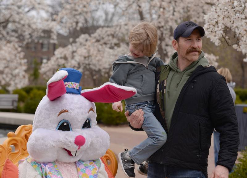 Steven McNichols of Chicago plays with the Easter Bunny's ears while him and his dad Steven get ready for their picture during the Easter Egg Hunt held at Cantigny  Sunday April 13, 2025.