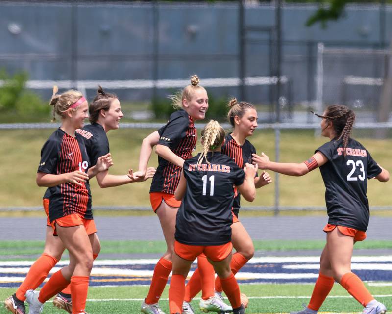 St. Charles East Grace Williams, center, gets congratulated by teammates after scoring a goal in the first half of the sectional title game against St. Charles North on Saturday May 27th held at West Chicago Community High School.