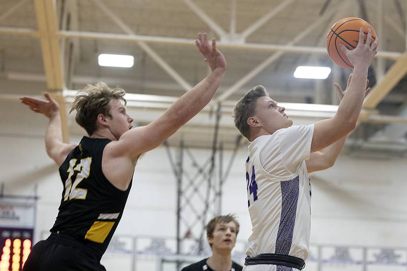 Dixon’s Eli Davidson puts a shot up past Elk Grove’s Dan Pasterski Saturday, Jan. 11, 2025.