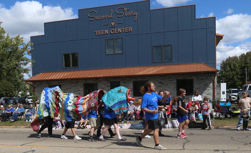 Teens with the Second Story Teen Center perform a dragon dance in front of the new Second Story Teen Center during the 54th annual Homestead Festival parade on Saturday, Sept. 6, 2025 in Princeton.