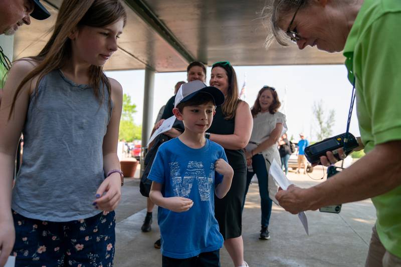 Sean King for the Daily Herald
Evie Mason, 11 and her brother Owen Mason, 8 of Huntley have their tickets scanned prior to the start of the Kane County Cougars opening day baseball game at Northwestern Medicine Field in Geneva on Friday, May 13, 2022.