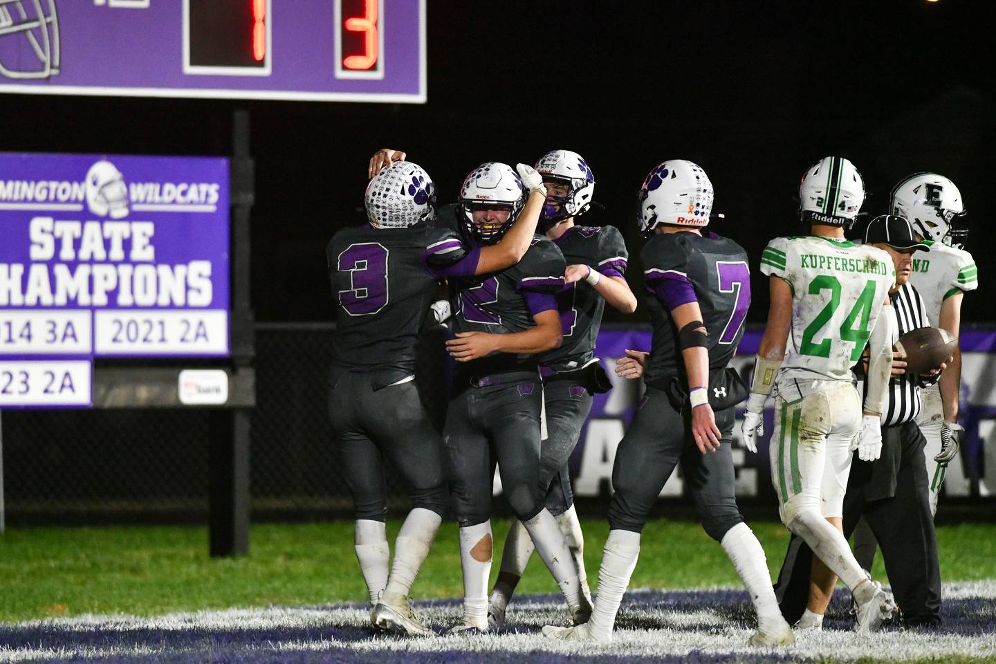 Wilmington's Lucas Rink, center, is congratulated by teammates after scoring a touchdown Saturday during the Wildcats' 36-0 victory over Eureka in the second round of IHSA Class 3A Playoffs.