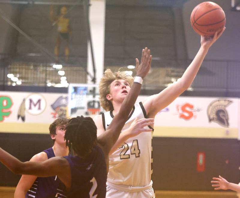 Sycamore's Lucas Winburn shoots over Plano's AJ Johnson Tuesday, Jan. 3, 2023, during their game at Sycamore High School.