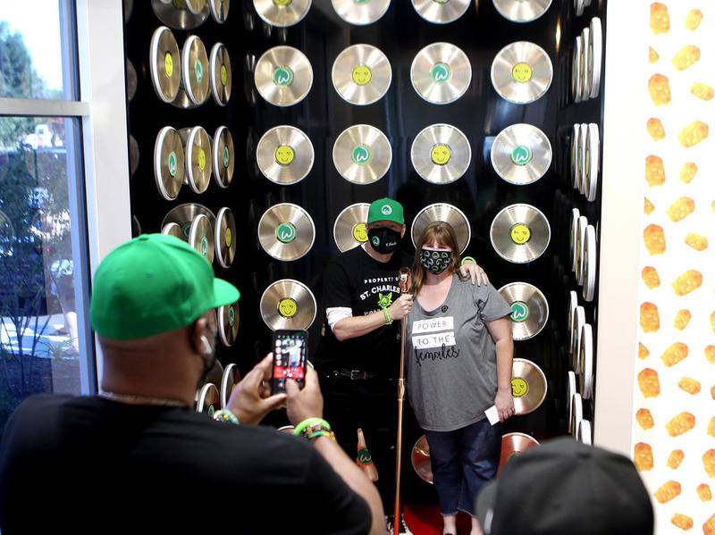 Donnie Wahlberg poses for a photo with Joyce Baehr of Bensenville during the opening of Wahlburgers in St. Charles on July 28.
