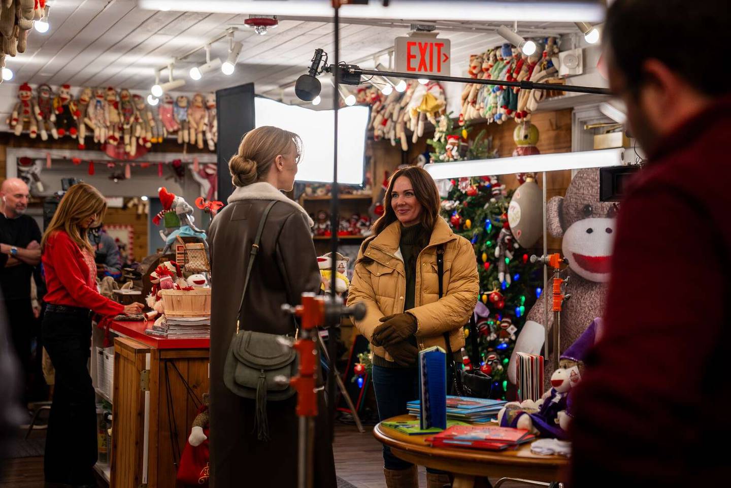 Actress Amy Sloan, left, and “Christmas on the Ranch” star Jade Harlow shoot scenes for the film at the Sock Monkey Museum in Long Grove.