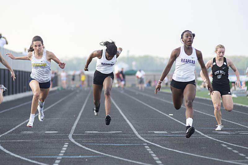 Sterling's Alice Soteloe (left), Amakari Favour of Plano, Armoney Clay of Plano and Rock Falls' Emily Spooner cross the finish line in the 100 dash at the 2A track sectionals in Geneseo on Wednesday, May 11, 2022.
