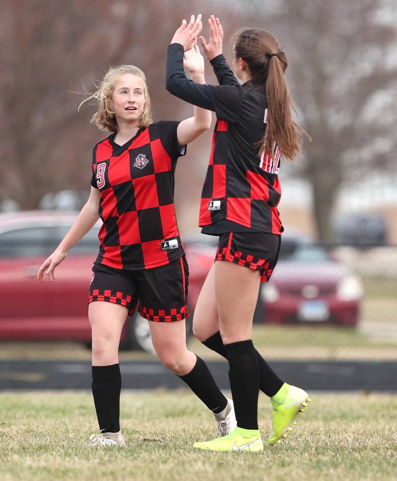Indian Creek's Isabella Turner (right) congratulates teammate Jolee Larson after she scored a goal during their game against DePue Tuesday, April 5, 2022, at Indian Creek Middle School in Waterman.