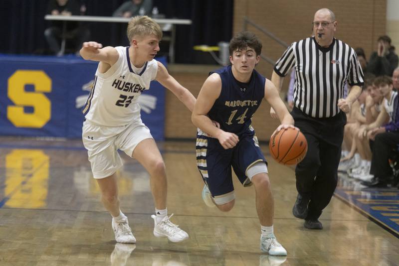 Marquette's Carson Zellers drives down the court against the defense of Serena's Tanner Faivre during the IHSA Class 1A boys basketball championship at Serena High School on February 23, 2024.