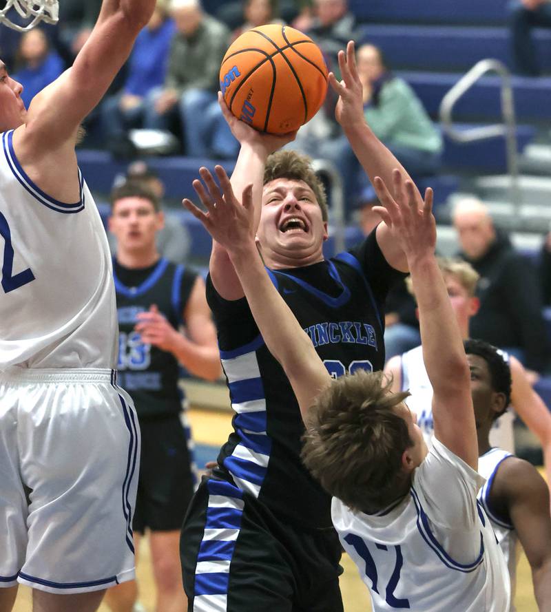 Hinckley-Big Rock's Luke Badal shoots between two Newark defenders Friday, Feb. 6, 2026, during their Little 10 Conference third place game at Somonauk High School.