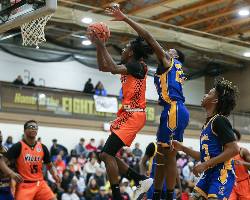 Romeoville's Kendall Cutler (14) puts up a shot defended by Joliet Central's Danny Thompson (23) in the WJOL Tournament Championship game. Nov 25, 2023.