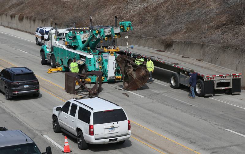 Crews with Senica Towing work the scene of a semi that struck the 7th Street bridge over Illinois Route 251 on Monday, March 10, 2025 in Peru. The semi was hauling two clamshell buckets for excavating equipment. The buckets struck the bridge and fell off of the flatbed onto Illinois Route 251.