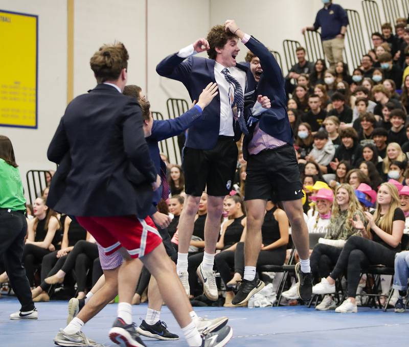The Lyons Township microfinance club celebrates after winning hula hoop hop during an all-school assembly in La Grange on Friday, April. 22, 2022.