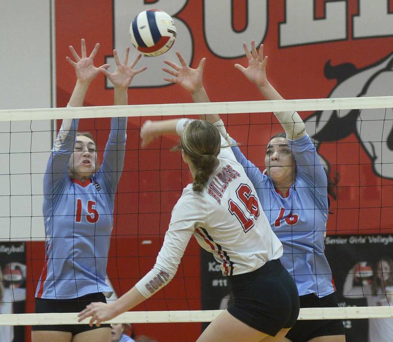 Ottawa’s Addison Duggan and Chey Joachim set to block a spike by Streator’s Devin Elias in the first match Thursday at Streator.