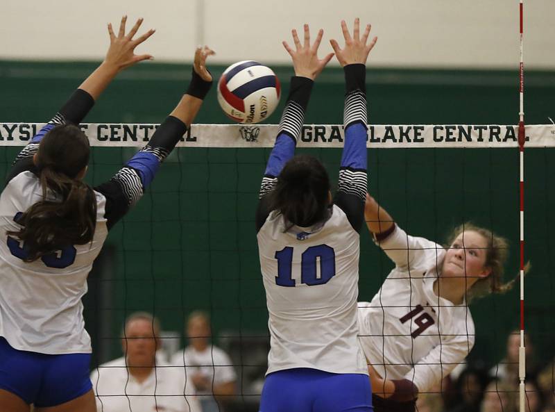 Prairie Ridge's Tegan Vrbancic hits the ball past the block of St. Francis' Meg Taylor during the IHSA Class 3A Grayslake Central Supersectional volleyball match on Monday, Nov. 11, 2024, at Grayslake Central High School.