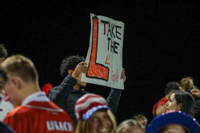 Fan of Streator holds sign reading “Take the L Lisle” on Friday, October 4, 2024 at Streator high school in Streator.