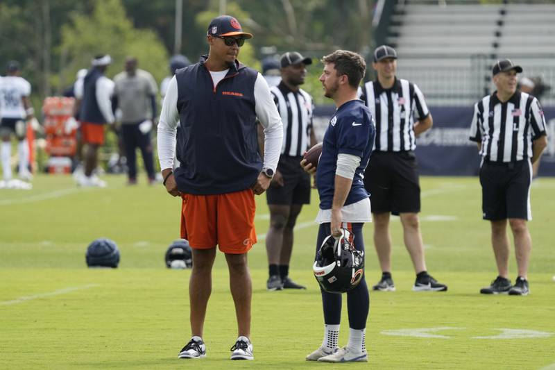 Chicago Bears general manager Ryan Poles, left, talks with kicker Cairo Santos during an NFL football training camp practice in Lake Forest, Ill., Monday, July 22, 2024. (AP Photo/Nam Y. Huh)