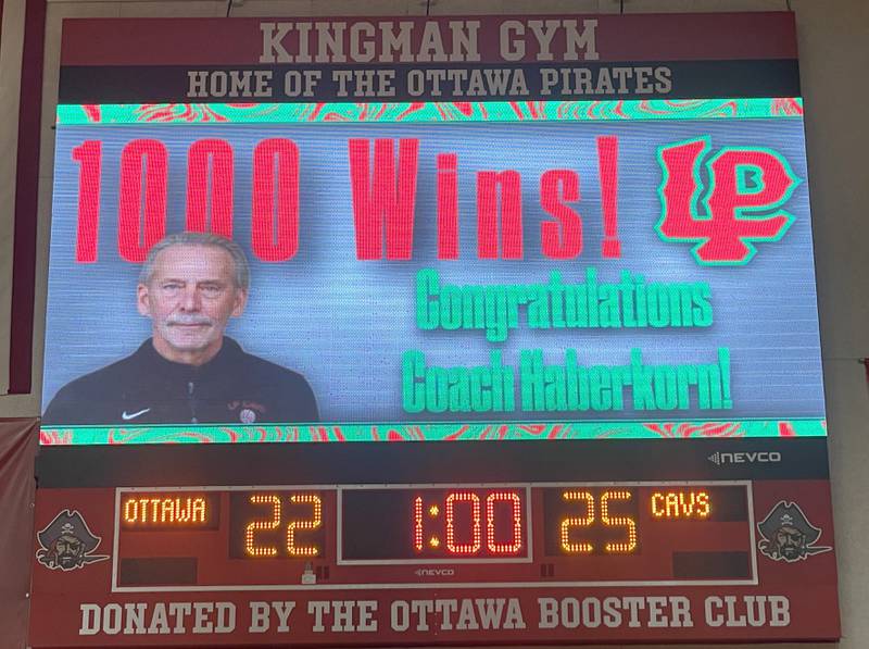 The video board congratulates L-P head coach Mark Haberkorn after getting his 1000th career win against Ottawa on Tuesday, Oct. 18, 2022 at Kingman Gymnasium in Ottawa.