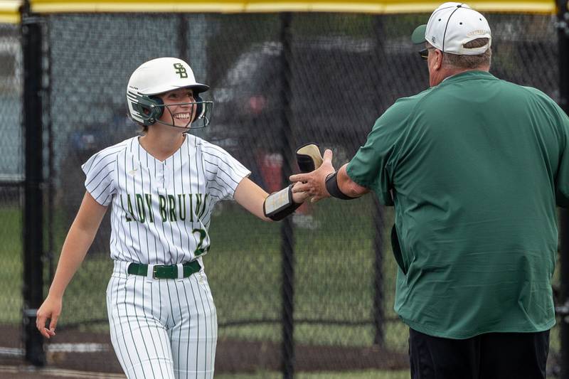 (26) Emma Slingsby of St. Bede gives batting equipment to coach Shawn Sons on Tuesday, May 27, 2025 at Illinois Valley Central High School in Chillicothe.