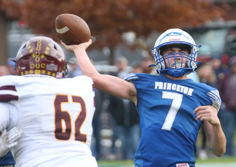 Princeton quarterback Gavin Lanham looks to throw a pass as Montini's Namari Anderson eyes the pass during the Class 3A quarterfinal game on Saturday, Nov. 16, 2024 at Bryant Field in Princeton.