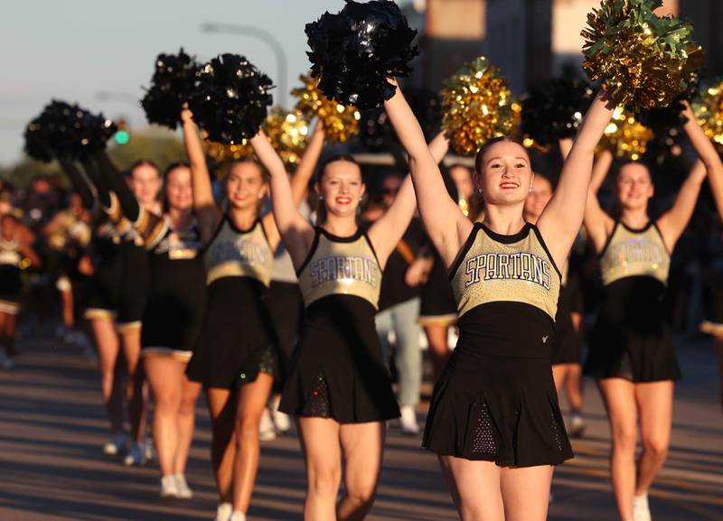 Members of the dance team make their way down State Street in Sycamore Wednesday, Sept. 25, 2024, during the Sycamore High School homecoming parade.
