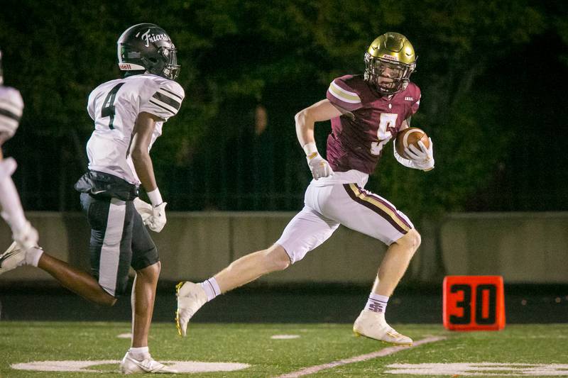 St. Ignatius receiver Jack Cronin (5) looks at defenders after catching a pass during the fourth quarter of the football game at Saint Ignatius College Prep on Friday, Oct. 22, 2021. The Wolfpack lost, 28-20.