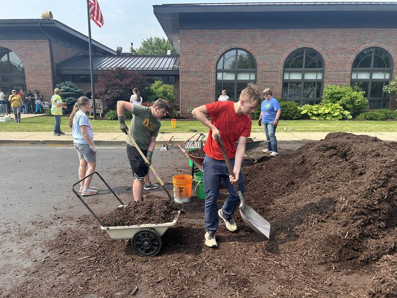 Macen Mulderink and Ian bush helped the with the Morrison Garden Club landscaping project at the Odell Public library on May 31.