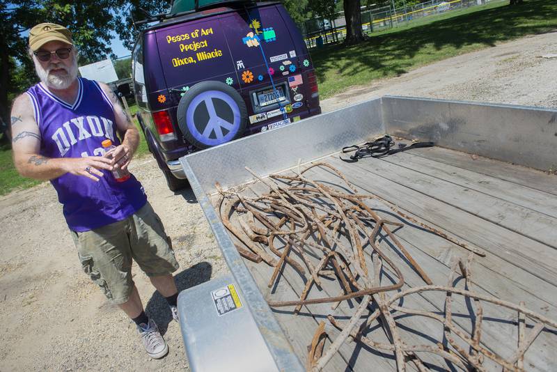 Mark Stach shows off his haul of twisted metal fished from the bottom of the Rock River in Dixon.  Stach believes the metal is from the Truesdell bridge disaster that took place on Sunday, May 4, 1873.