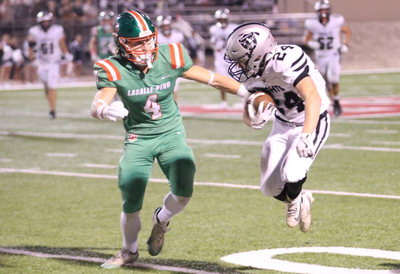 Kaneland's Gavin Klein carries the ball as L-P's Mason Morscheiser looks to make the tackle on Friday, Oct. 17, 2025 at Howard Fellows Stadium.