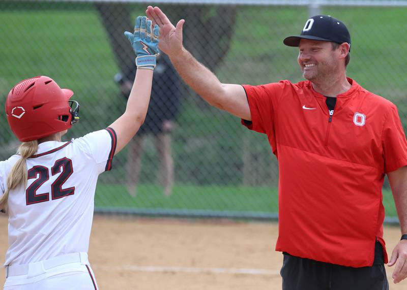 Ottawa's Joslyn Rose gets a high five from head coach Adam Lewis after homering Friday, April 17, 2026, during thier game at Sycamore High School.